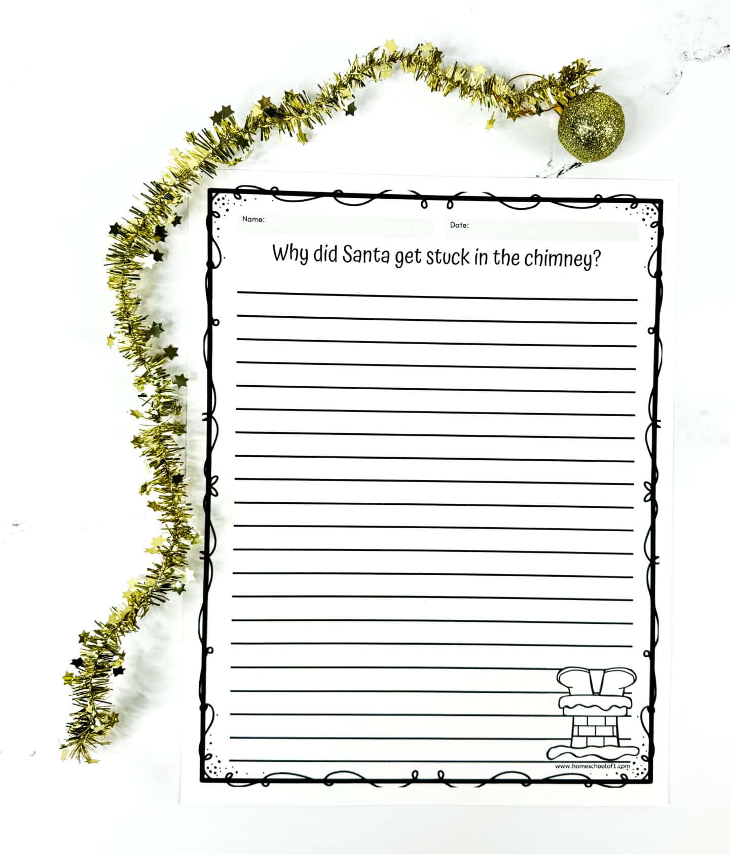 A playful Christmas writing prompt worksheet titled “Why did Santa get stuck in the chimney?” features lined space for kids to write their imaginative answers. The page is bordered with a whimsical black doodle frame and includes a small illustration of Santa’s boots sticking out of a chimney in the bottom right corner. Gold tinsel garland and a glittery ornament rest above the page, adding a festive holiday feel.

