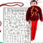 Black-and-white Elf I Spy game printable with Elf on the Shelf doll and red beads.
