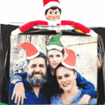 Printable elf hats added to a family photo with Elf on the Shelf sitting above the frame.
