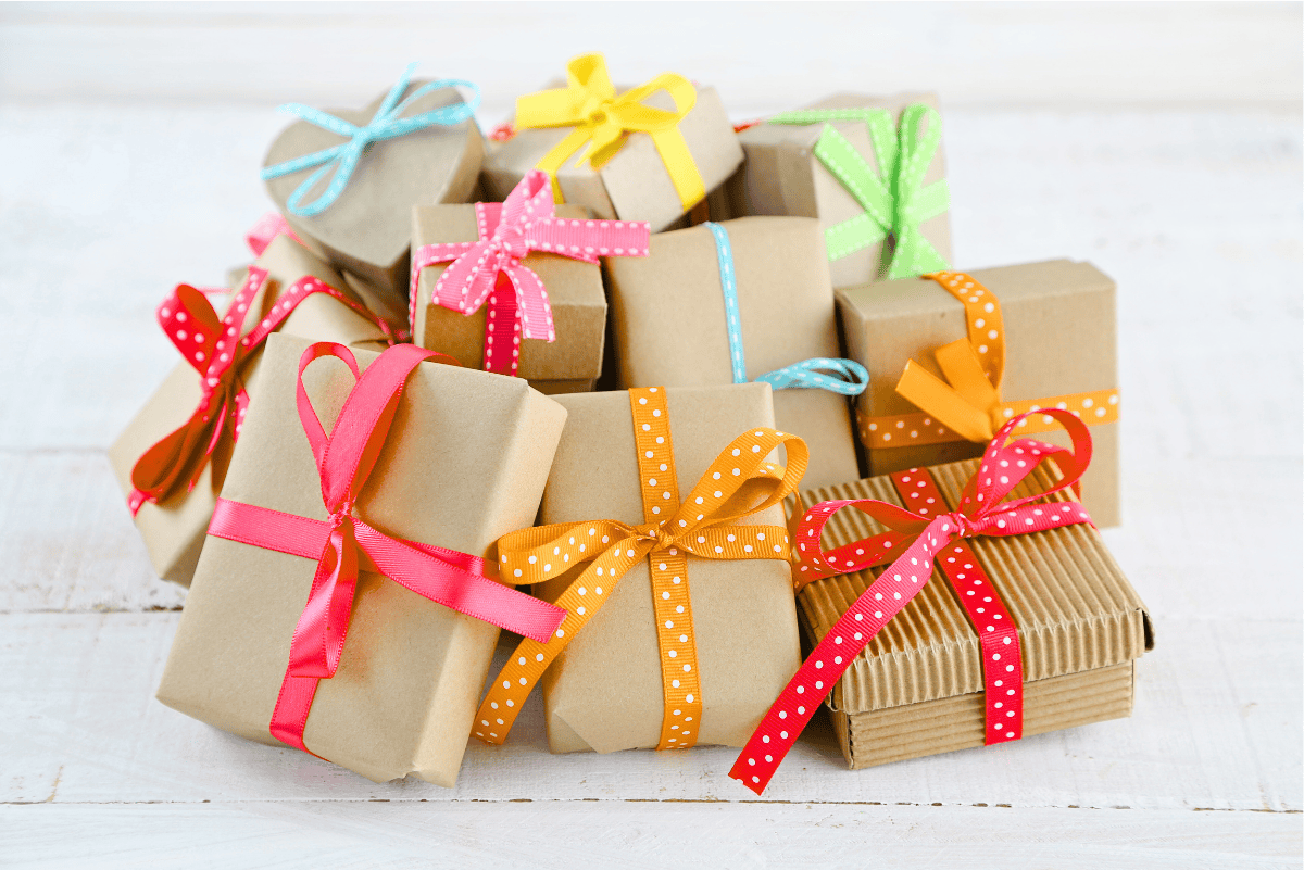 Stack of brown paper–wrapped gifts tied with colorful polka dot ribbons, symbolizing creative and thoughtful homeschool presents.