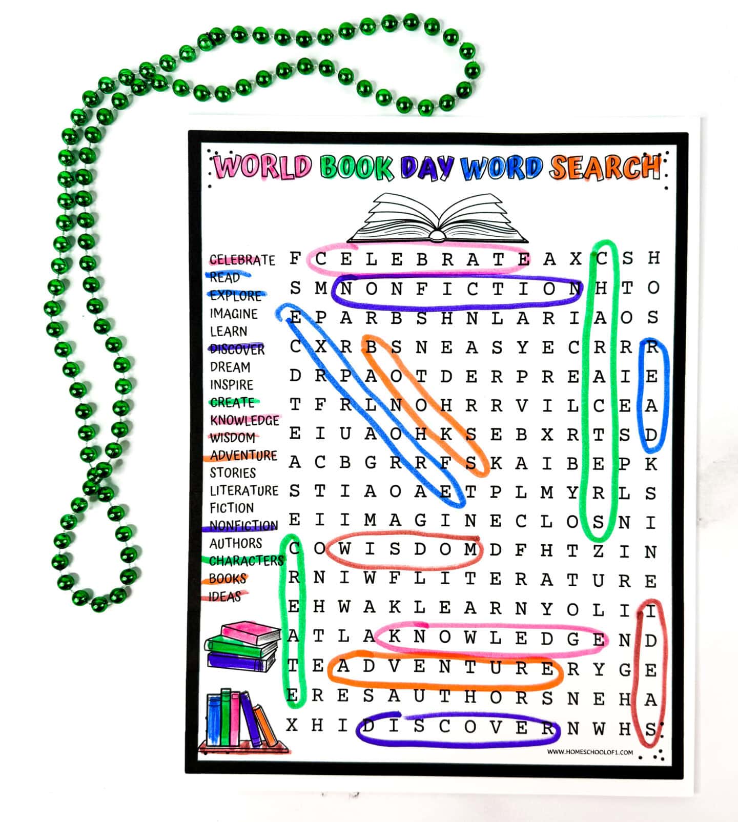 Bright and playful “World Book Day Word Search” activity page with the title in rainbow letters and a grid of book-themed words, many of which are circled in various colors. Words like “CELEBRATE,” “KNOWLEDGE,” “DISCOVER,” and “READ” are highlighted in pink, purple, green, orange, and blue. A green beaded necklace loops around the top and left sides, with illustrated books at the bottom left adding a fun reading vibe.

