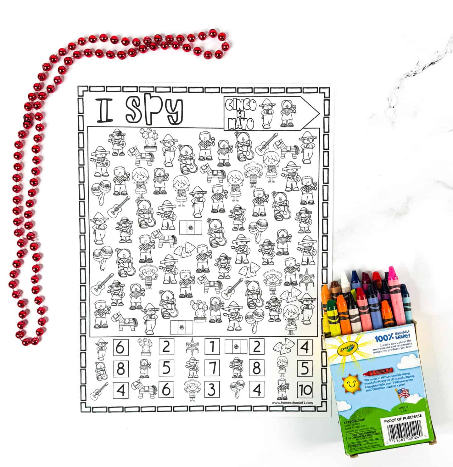 Cinco de Mayo I Spy worksheet completed with image totals shown at the bottom, alongside red party beads and crayons. This answer key includes Mexican-themed graphics like guitars, sombreros, tacos, and maracas—perfect for teachers or parents to check student work.
