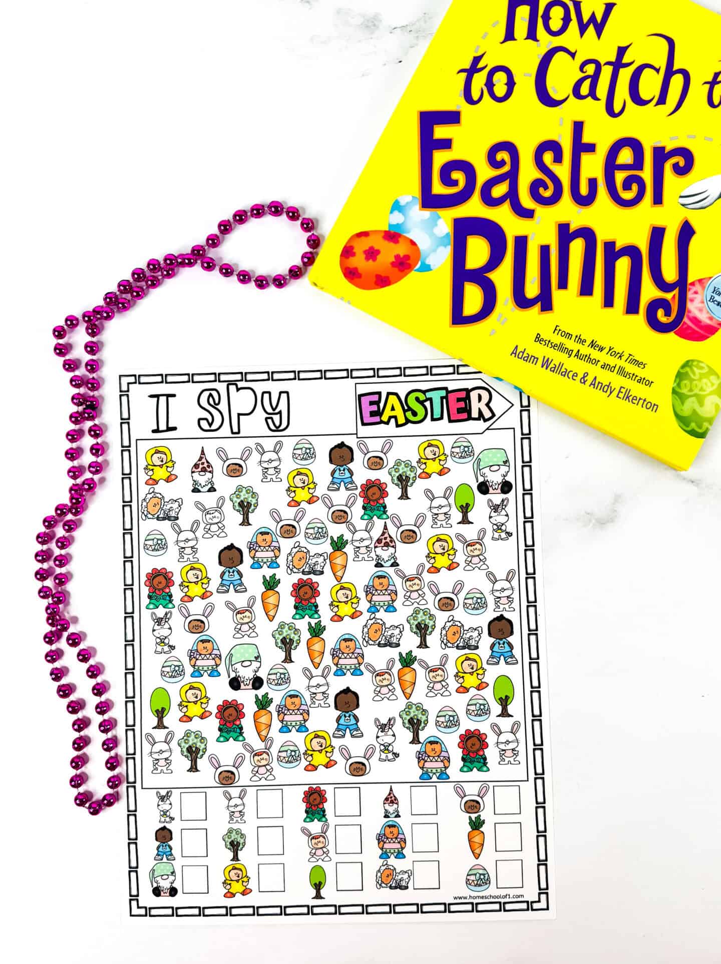 A colorful Easter-themed "I Spy" printable lies next to the children’s book How to Catch the Easter Bunny and a strand of pink beads. The game features bright icons like carrots, eggs, bunnies, kids in costumes, flowers, and trees, perfect for a festive holiday activity.