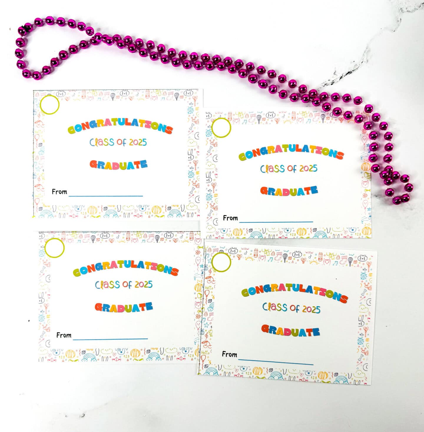 Four colorful gift tags that read "Congratulations Class of 2025 Graduate" bordered with playful doodles, with blank spaces labeled "From", and a string of shiny purple beads above them.