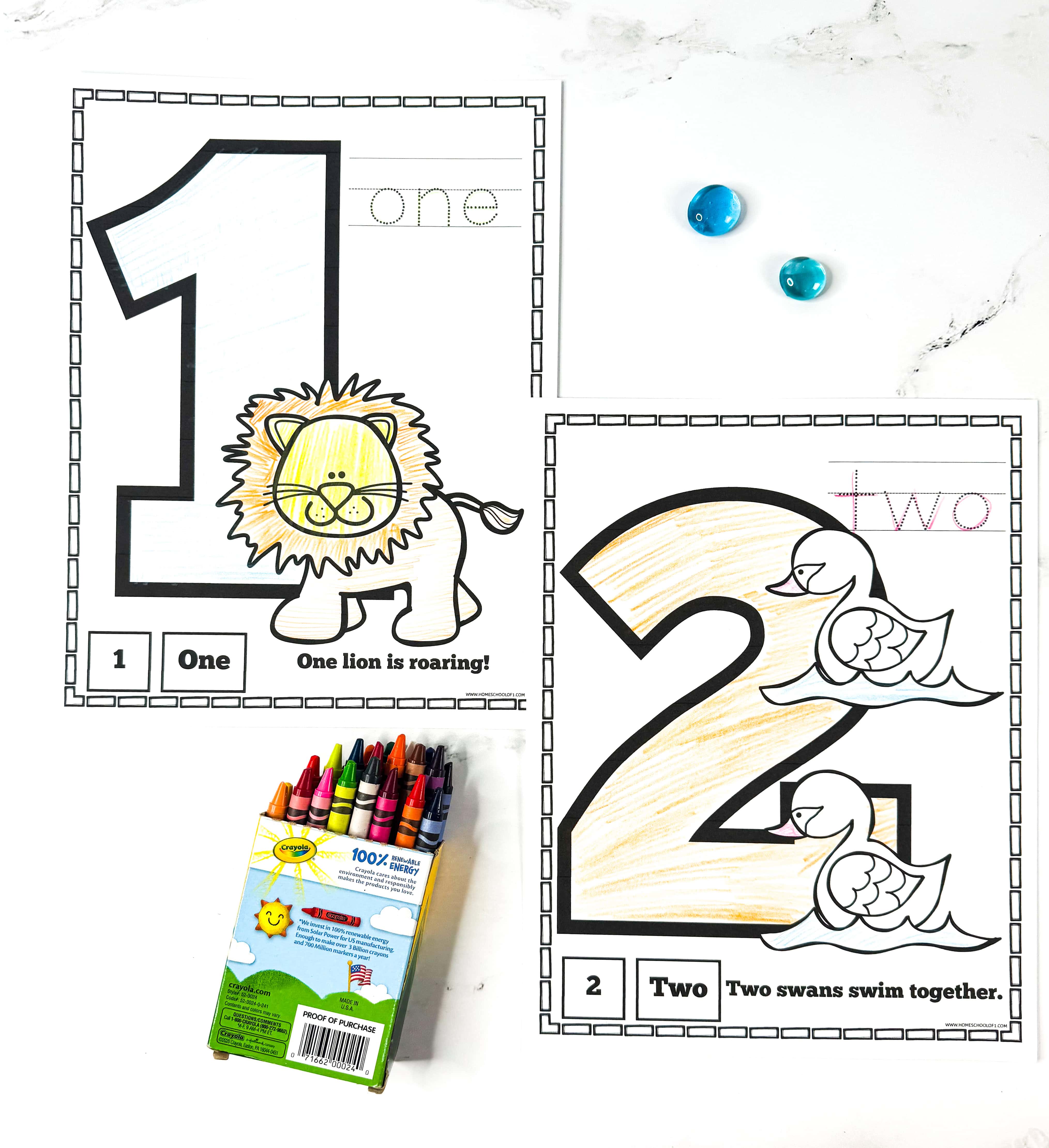 Free printable number coloring pages for numbers 1 and 2 with a lion roaring and swans swimming.