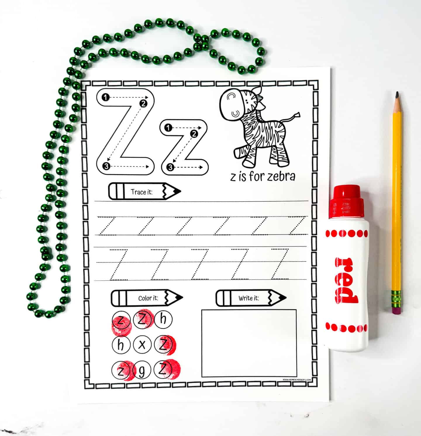 Letter Z tracing worksheet with a zebra illustration, multiple tracing rows, letter recognition dots, and a blank box for writing.