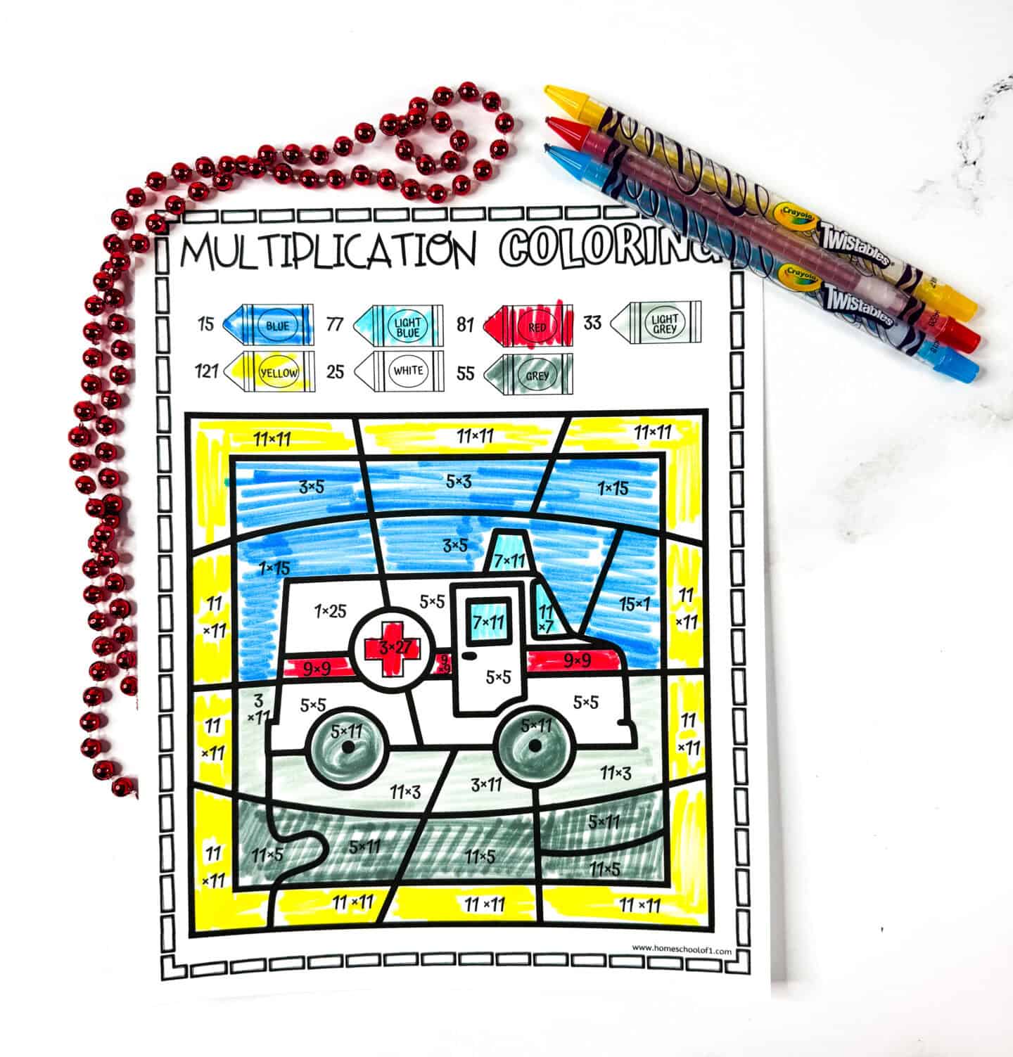 Multiplication coloring worksheet with a red and white ambulance revealed through solving math problems and matching colors.