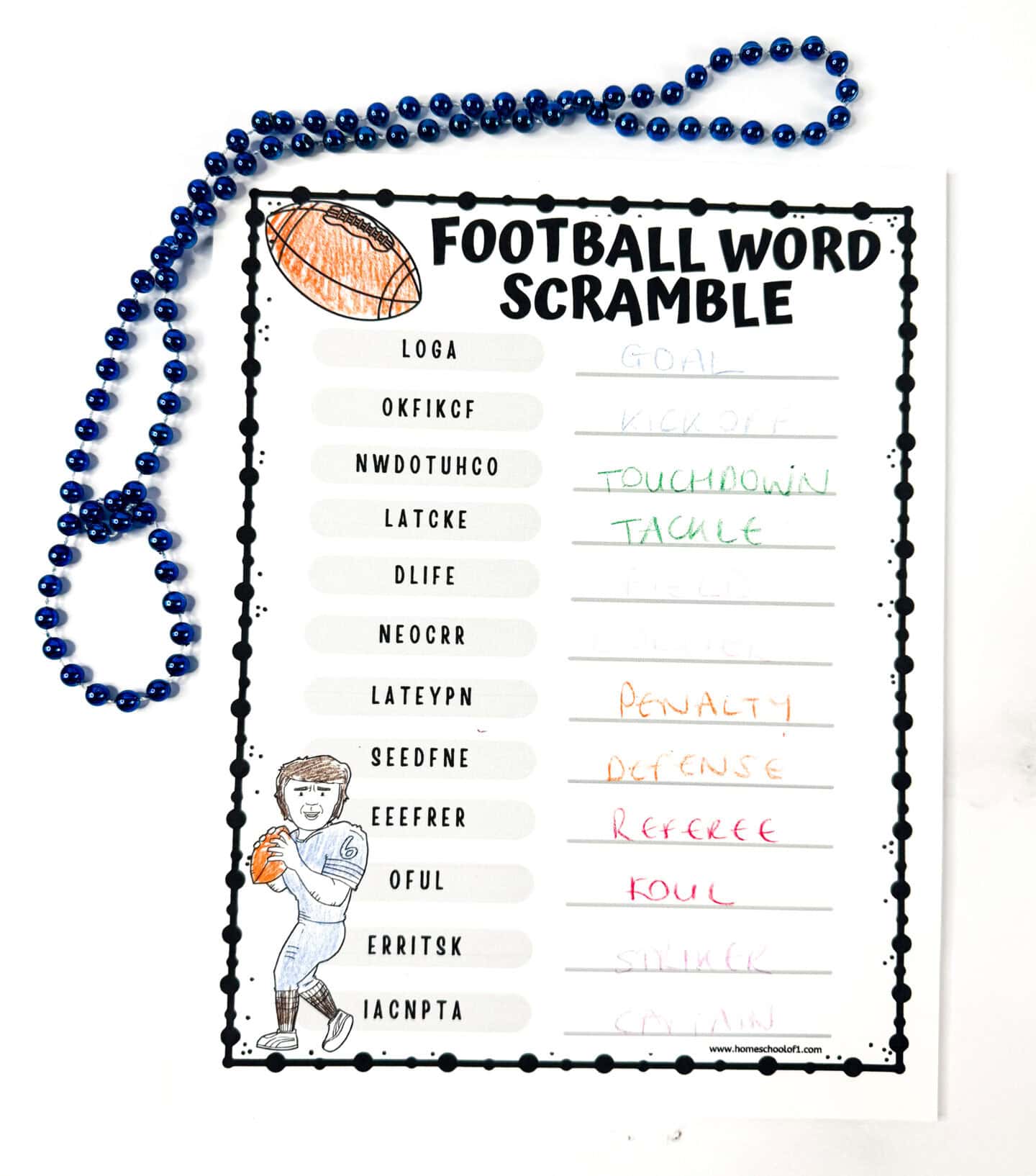 Completed football word scramble worksheet with 12 unscrambled sports-themed words, colored football player, and blue beaded necklace