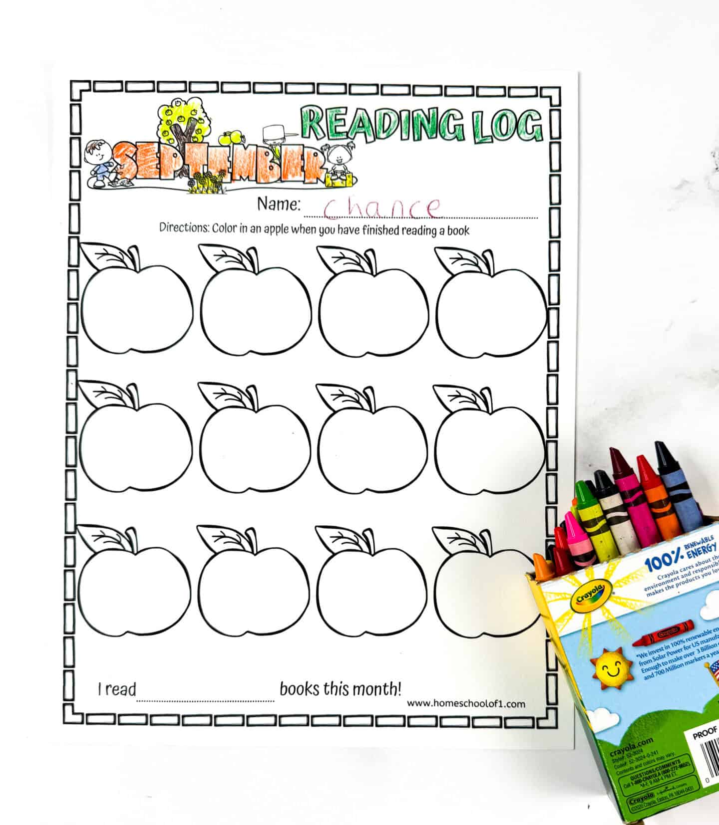 Partially completed September reading log with the name “Chance” written at the top, header colored, apples left blank, and a box of Crayola crayons on the right side.