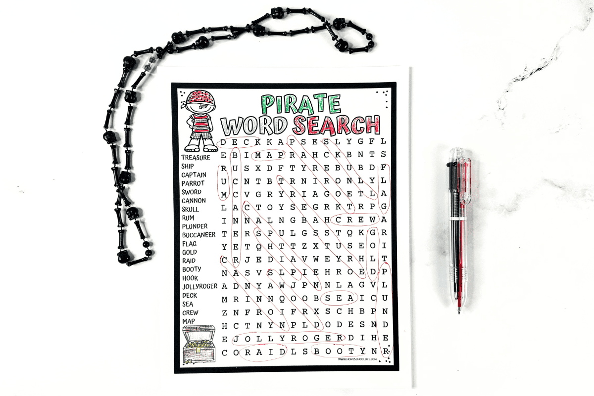 Pirate word search puzzle with circled answers, cartoon pirate, treasure chest, black beaded necklace, and multicolor pen.