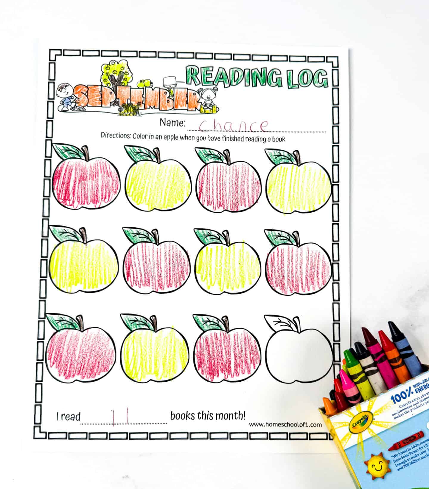 Completed September reading log with the name “Chance” written at the top, apples colored in red and yellow, and a box of Crayola crayons on the right side.