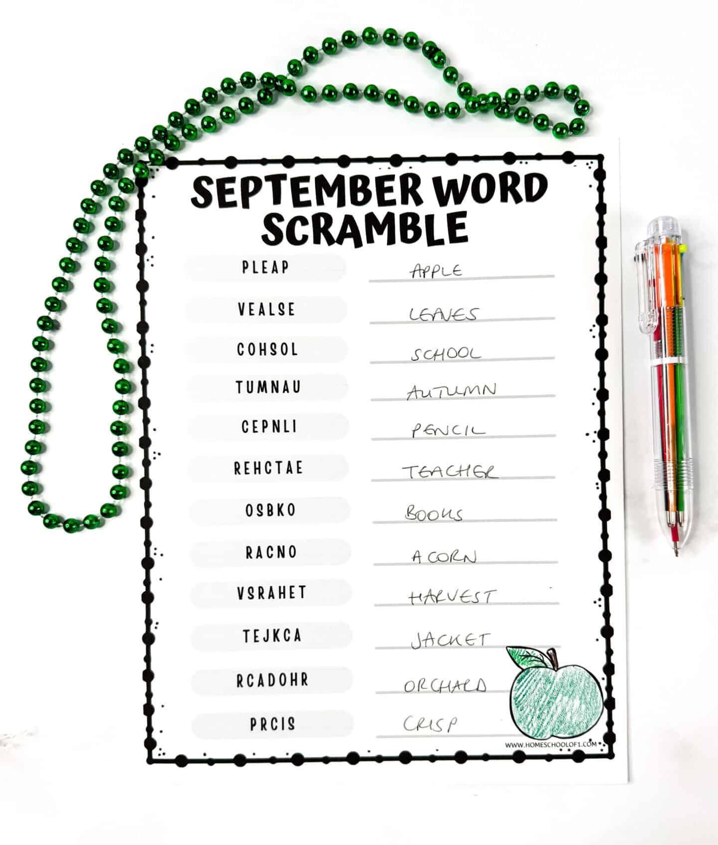 Finished September word scramble worksheet with answers written in pencil and a colored apple illustration.