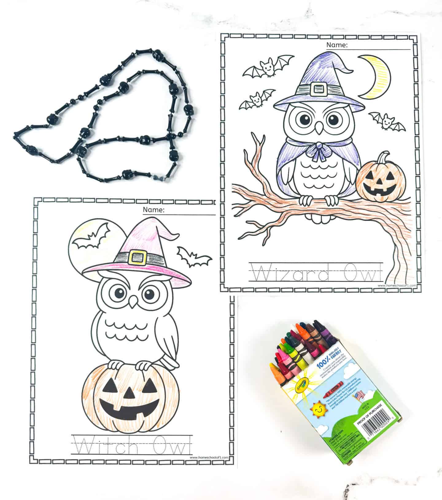 Halloween-themed owl coloring pages featuring a witch owl on a pumpkin and a wizard owl with bats and a jack-o’-lantern, displayed partly colored with a box of crayons and black bead decorations.