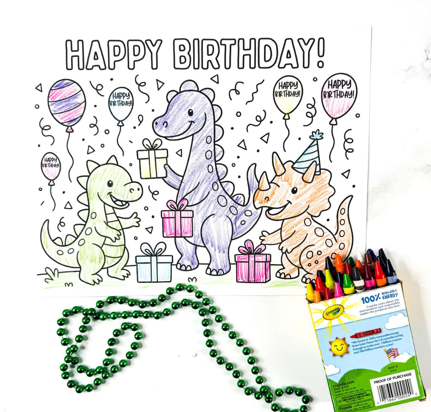 Dinosaur-themed Happy Birthday coloring page with three dinos in party hats holding gifts, surrounded by balloons, confetti, and crayons.