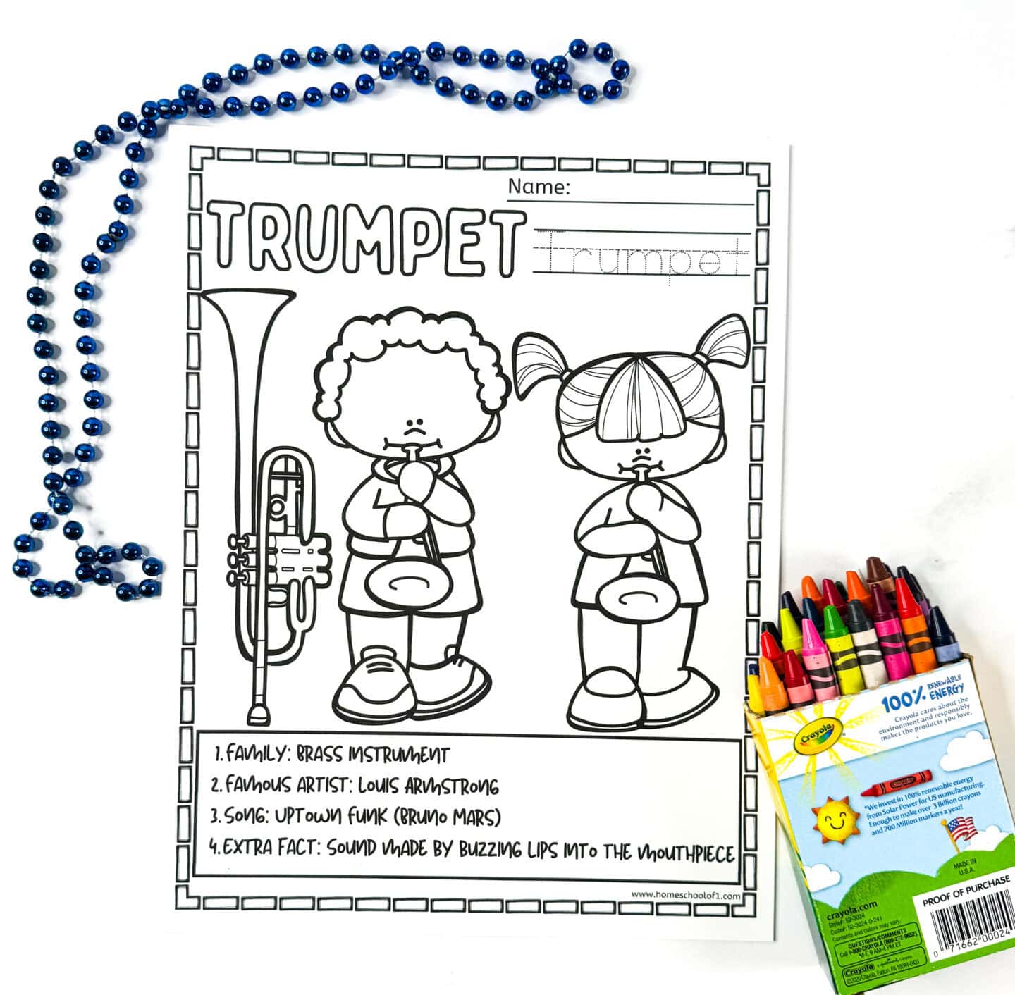 Trumpet coloring page for kids with black-and-white illustrations of two children playing trumpet, blue beads, and a box of crayons.