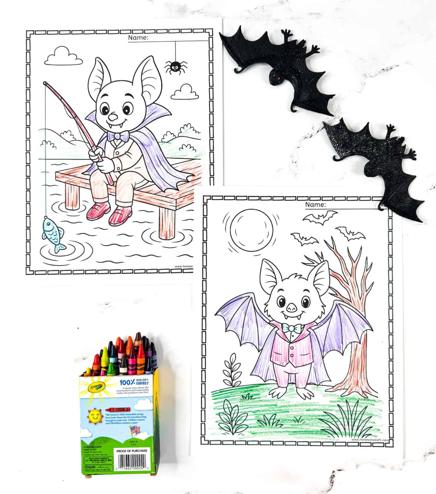 Two cute bat coloring pages for kids—one bat dressed as a vampire fishing on a dock, and one in a cape standing in front of a full moon and leafless tree. Crayons and bat decorations complete the scene.