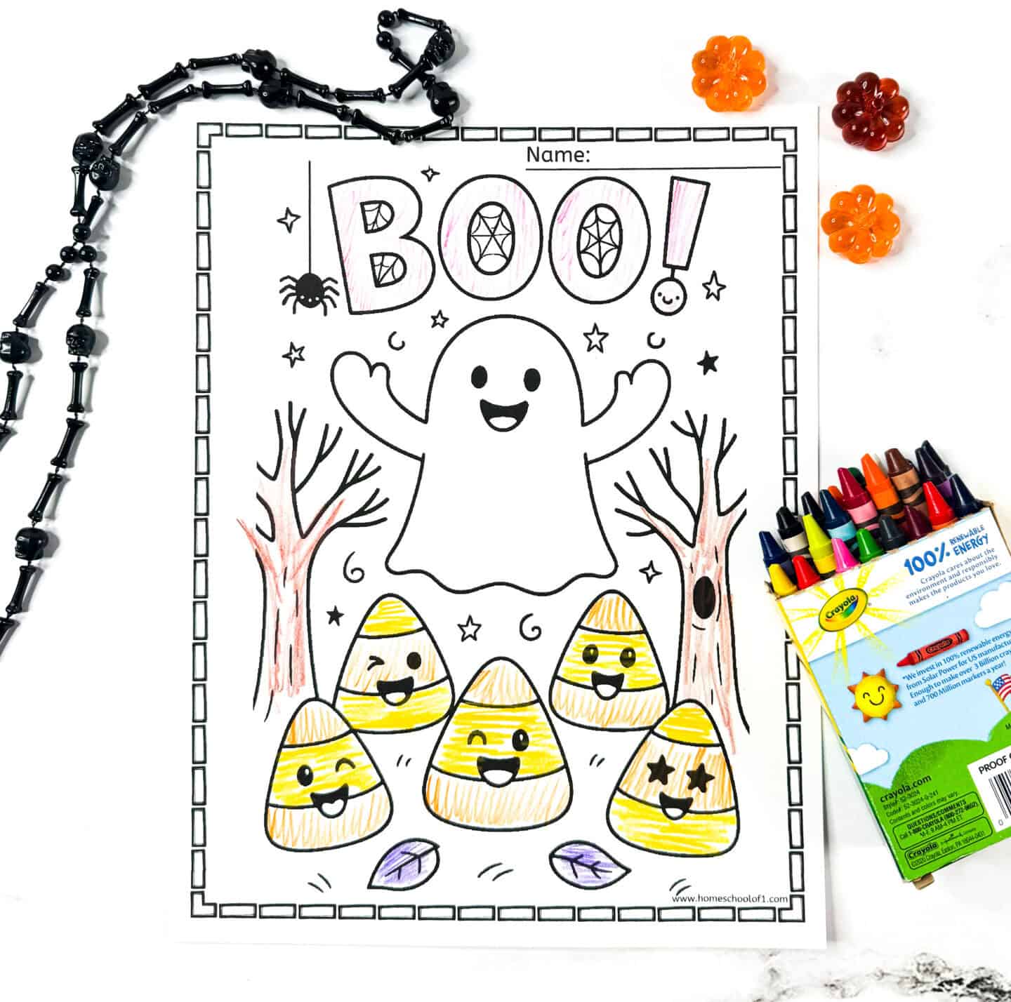 Happy ghost saying “BOO!” with smiling candy corn and trees. Halloween ghost coloring sheet for preschoolers.
