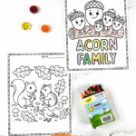 Acorn family coloring pages for kids with smiling acorns, squirrels, and fall leaves next to crayons.