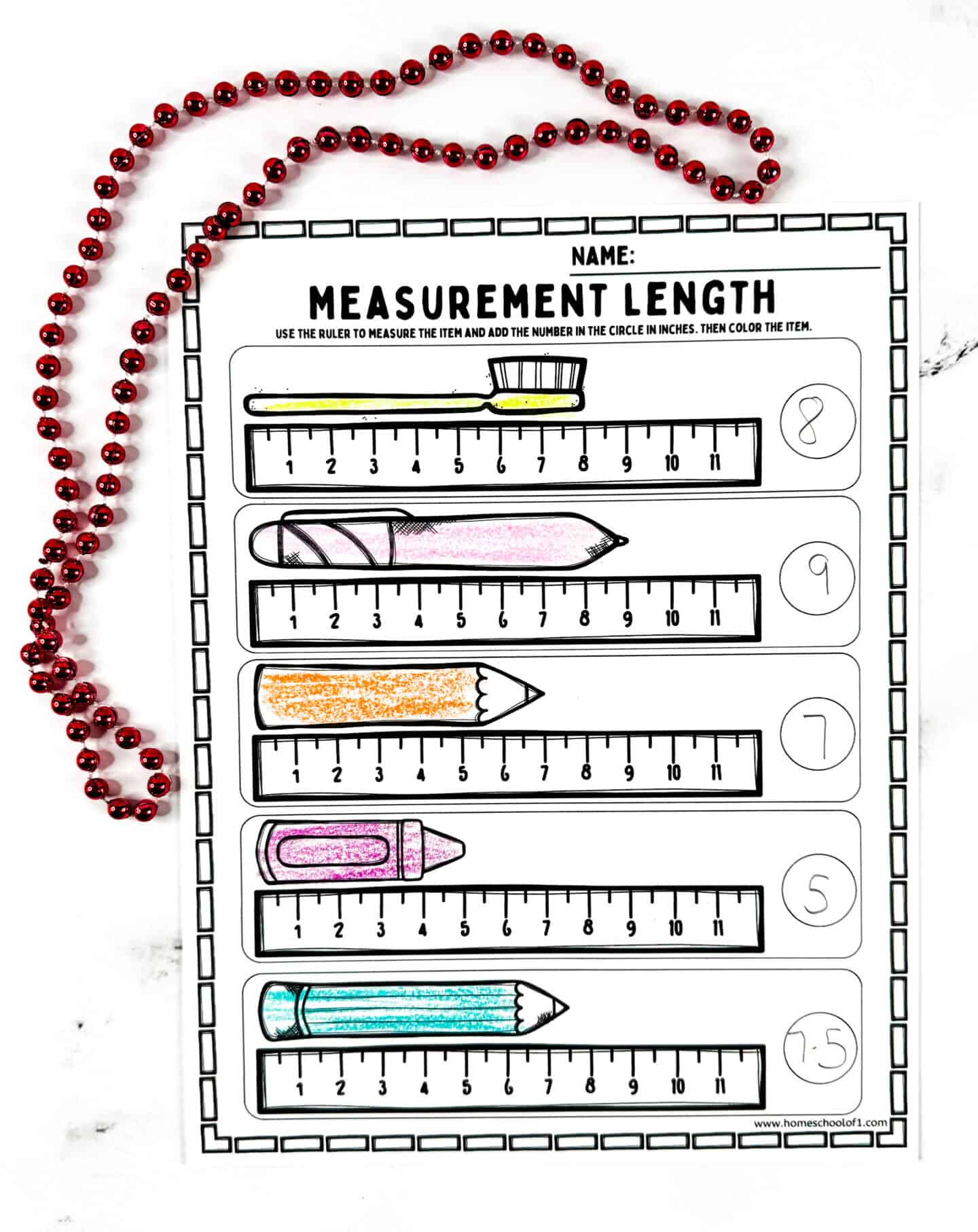 Printable measurement length worksheet for kids showing a toothbrush, pencil, and crayon measured in inches with colorful markings and a red bead border.
