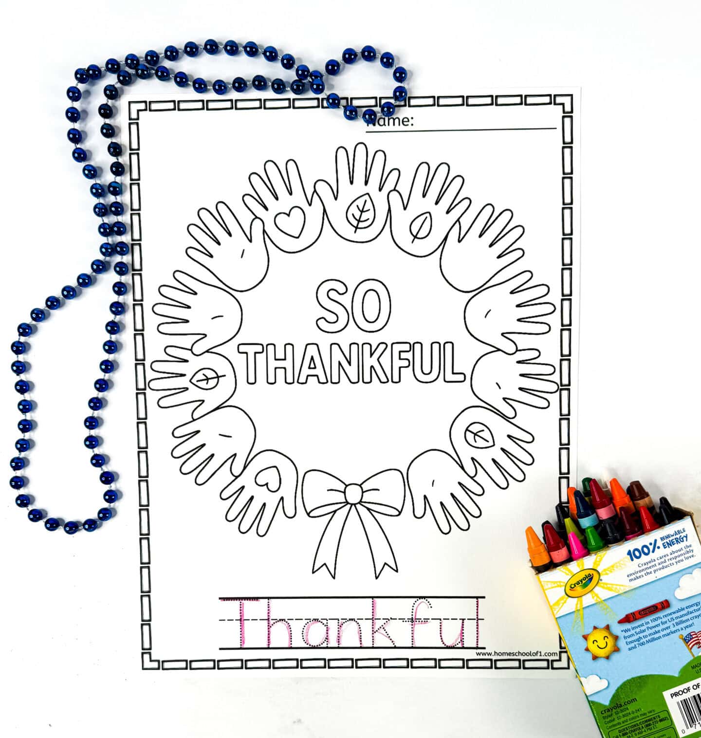 So thankful coloring page with a handprint wreath and space for children to trace the word "thankful" at the bottom.