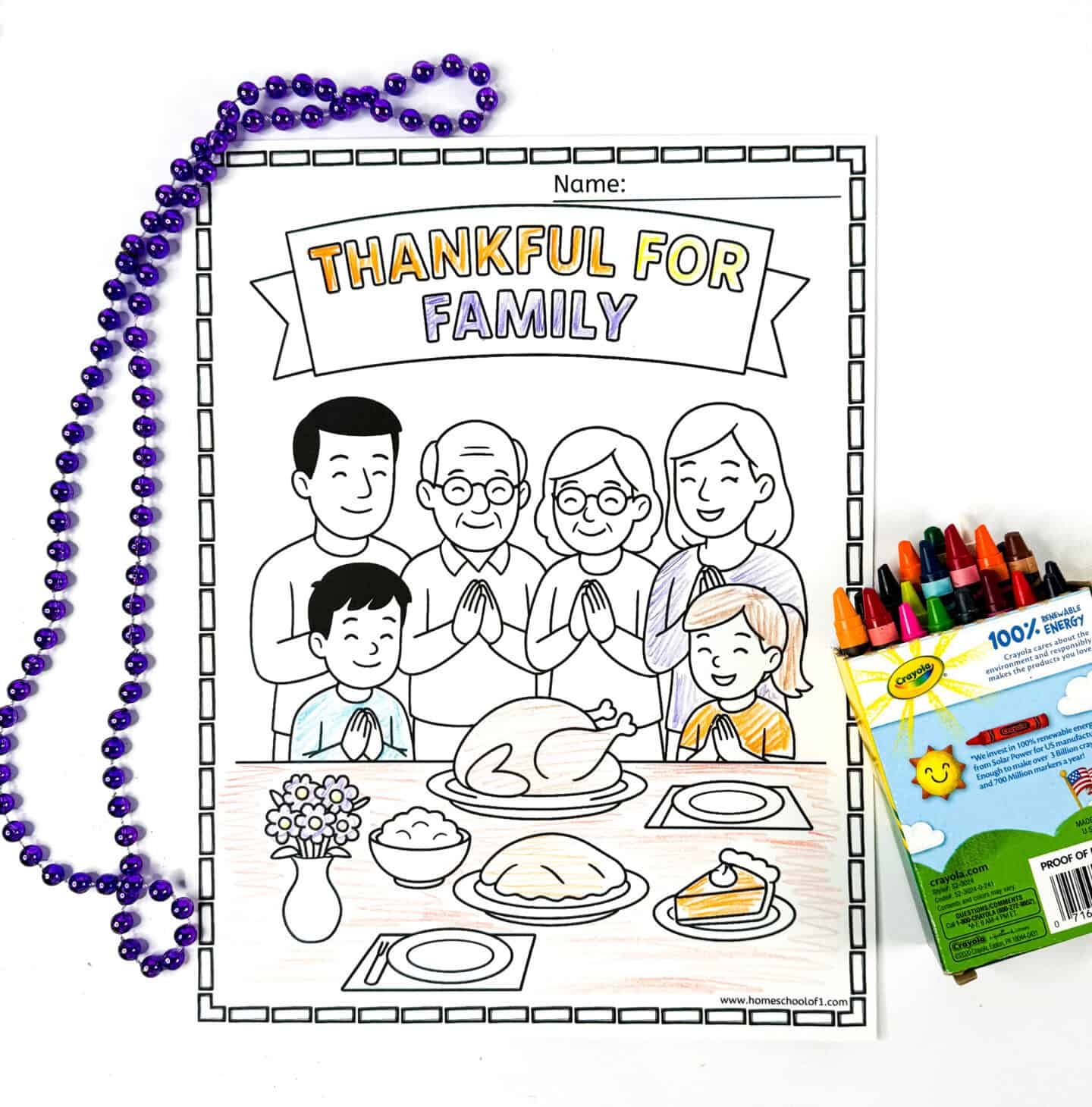 Thankful for family coloring page with parents, grandparents, and kids praying around a Thanksgiving dinner table.