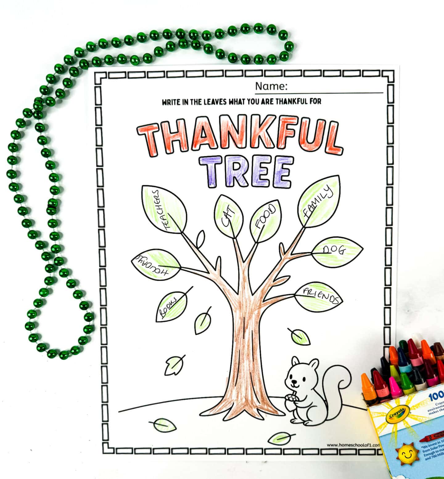 Thankful tree coloring page with space to write what kids are thankful for in the leaves and a squirrel holding a nut.