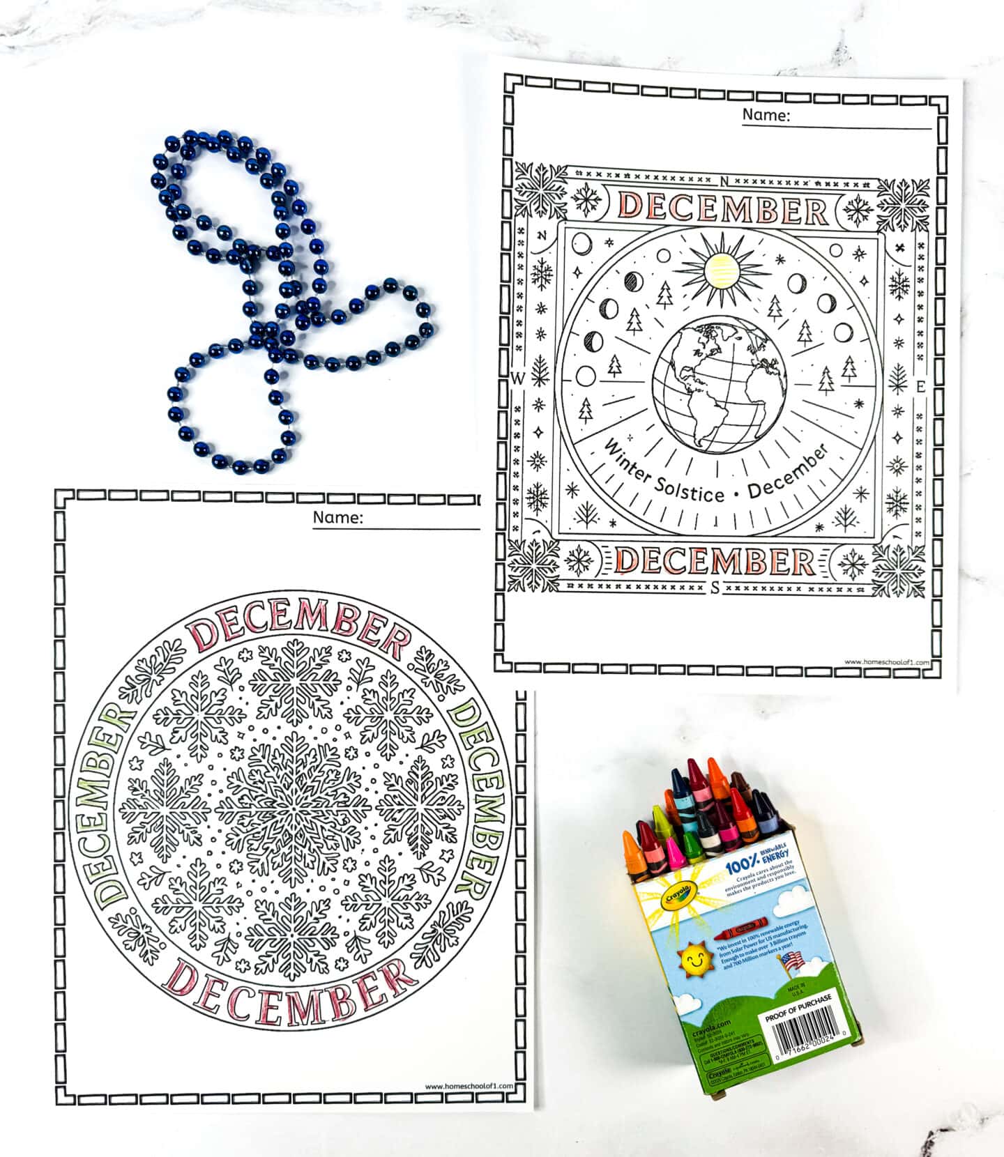 Two detailed December mandala coloring pages, one snowflake circle and one winter solstice design with Earth’s orbit, next to crayons and blue beads