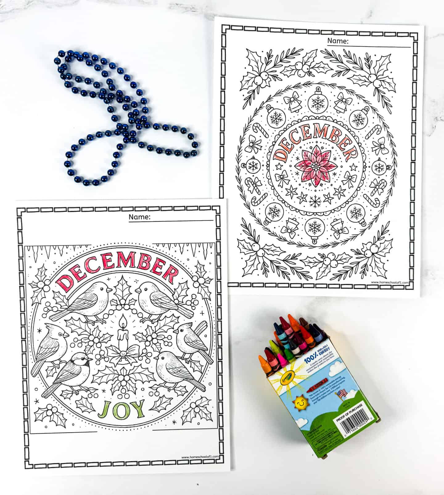 Two December mandala coloring pages featuring birds, holly, and poinsettia patterns with “December” and “December Joy” text, shown with crayons and blue beads.