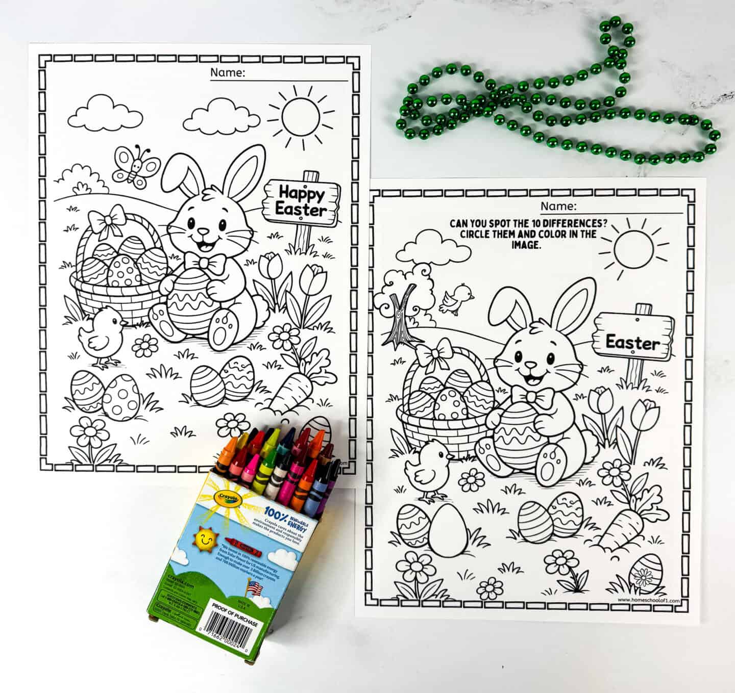 Two Easter spot the difference coloring pages printed side by side with crayons and green beads on a white background.
