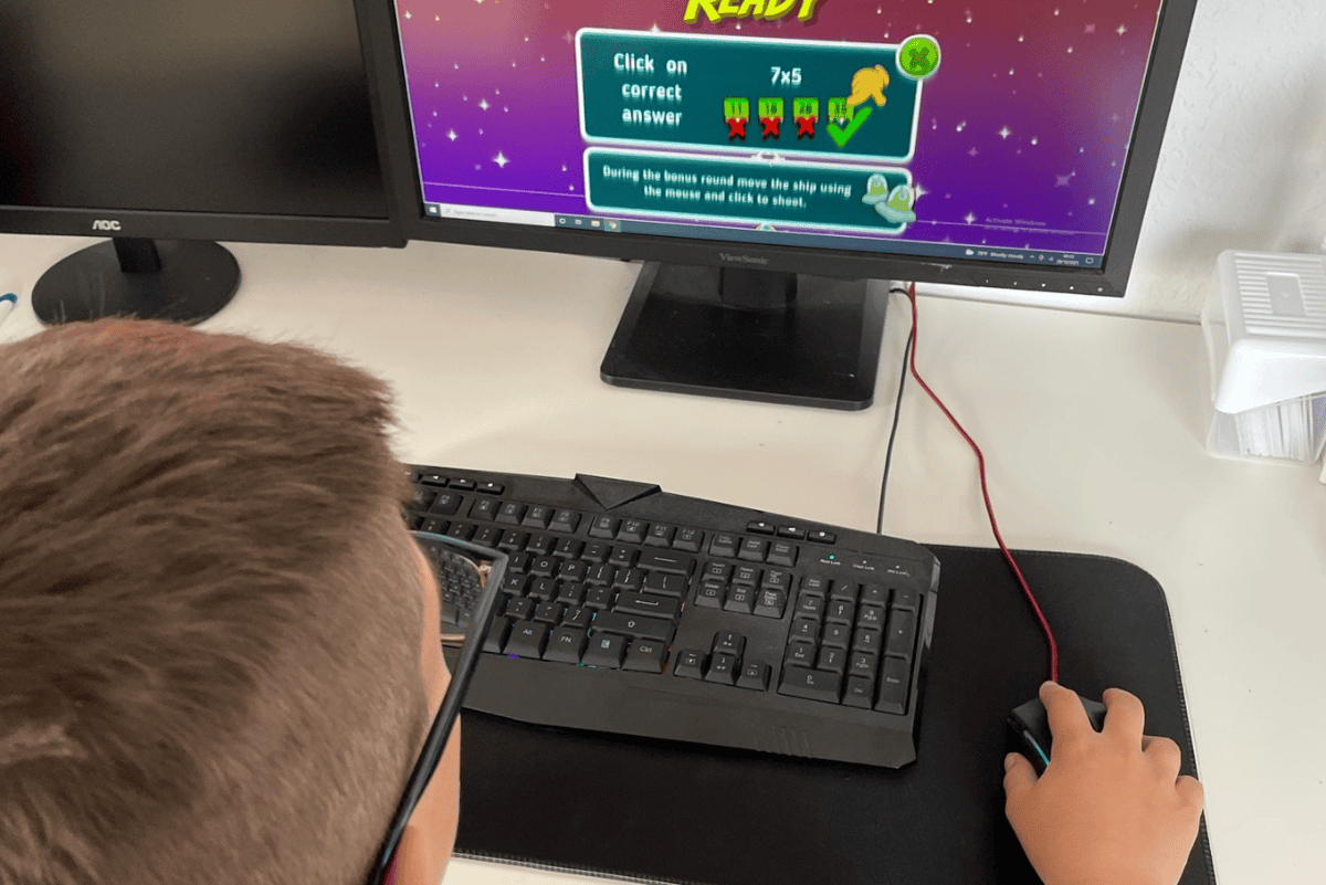 Child completing an online math lesson while homeschooling at home