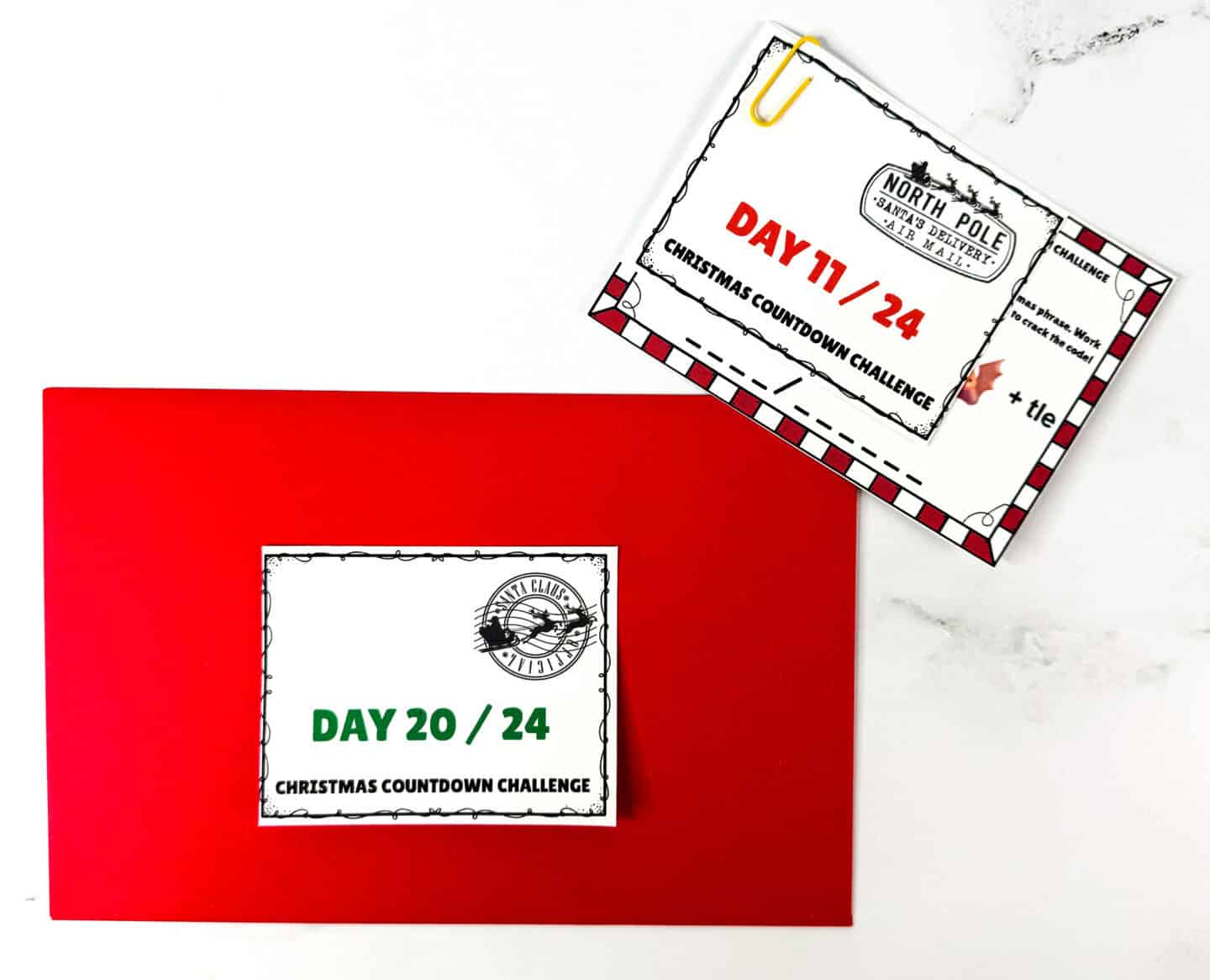 Red envelope with numbered Christmas Advent label and paper-clipped puzzle card