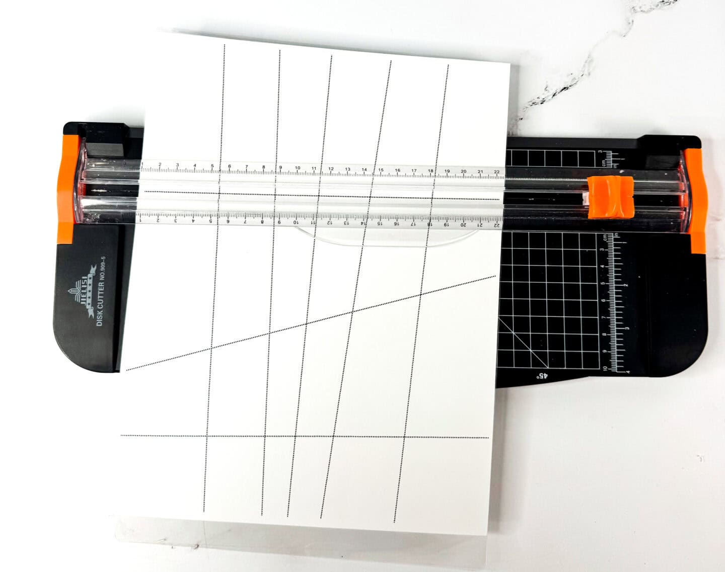Paper trimmer cutting the 24-piece Christmas mystery picture guide