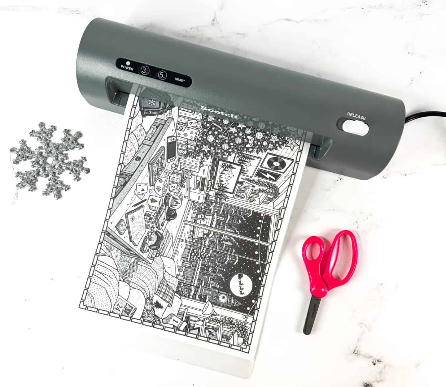 Christmas mystery picture going through a laminator before cutting
